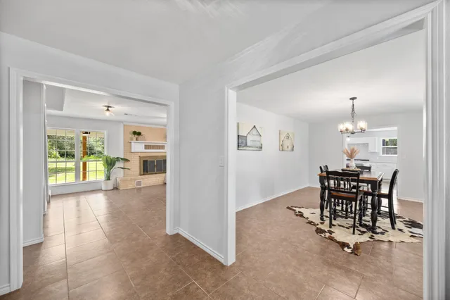a view of a dining room with furniture and a floor to ceiling window