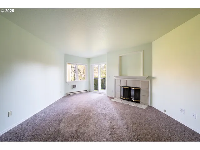 a view of empty room with a fireplace