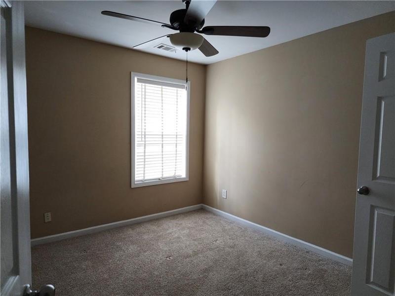 5079 Sherwood Way Cumming, GA 30040 - Photo 11 of 14 an empty room with a window and a fan