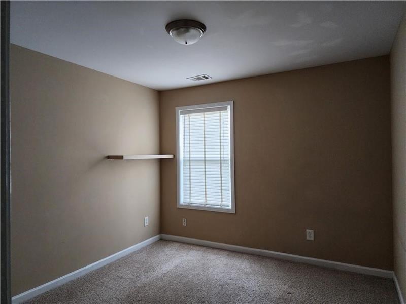5079 Sherwood Way Cumming, GA 30040 - Photo 12 of 14 an empty room with windows