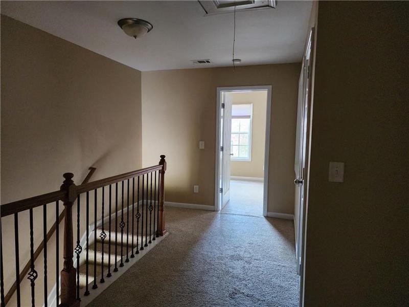 5079 Sherwood Way Cumming, GA 30040 - Photo 13 of 14 a view of a hallway with wooden floor and entryway