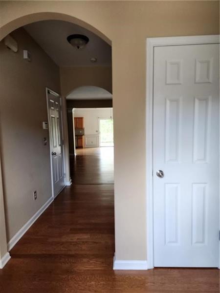5079 Sherwood Way Cumming, GA 30040 - Photo 4 of 14 a view of a hallway with wooden floor and closet area