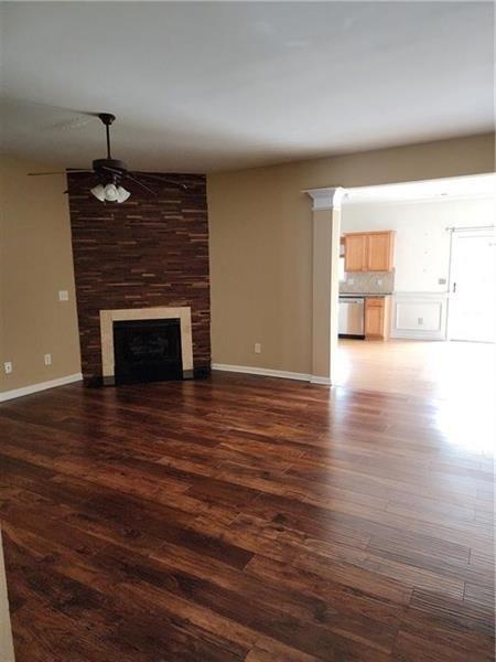 5079 Sherwood Way Cumming, GA 30040 - Photo 5 of 14 a view of empty room with wooden floor and fireplace