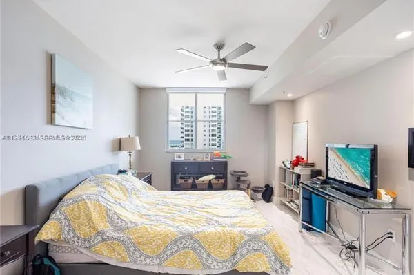 a bedroom with a bed and flat screen tv