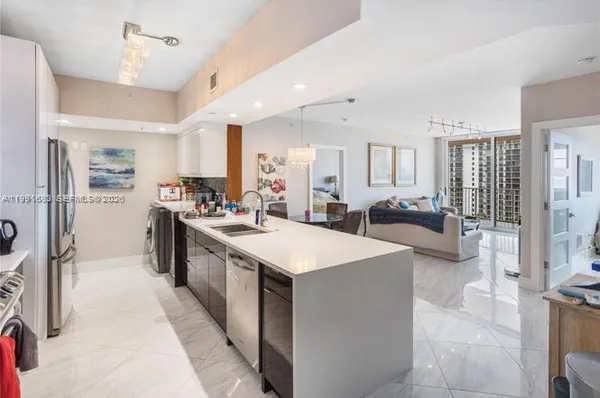 a large white kitchen with a large window