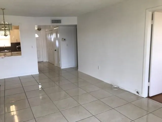 a view of a hallway with chandelier