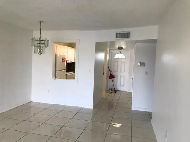 a view of a hallway with chandelier