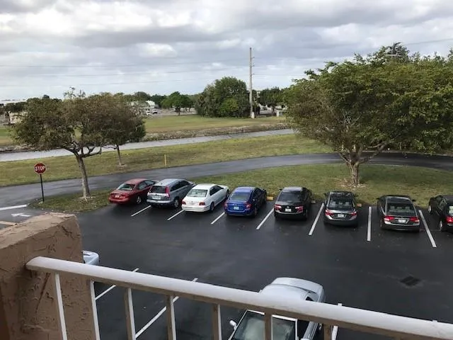 a view of a lake with a car parked on the road
