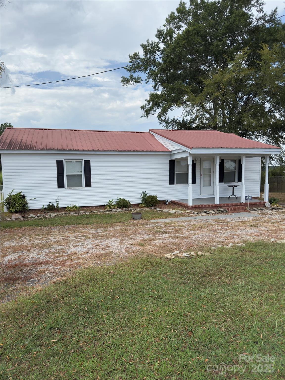 9697 Highway 52 Ansonville, NC 28170 - Photo 1 of 13 a front view of a house with a yard