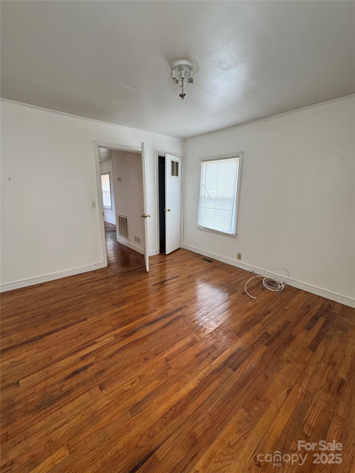 9697 Highway 52 Ansonville, NC 28170 - Photo 6 of 13 an empty room with wooden floor and windows