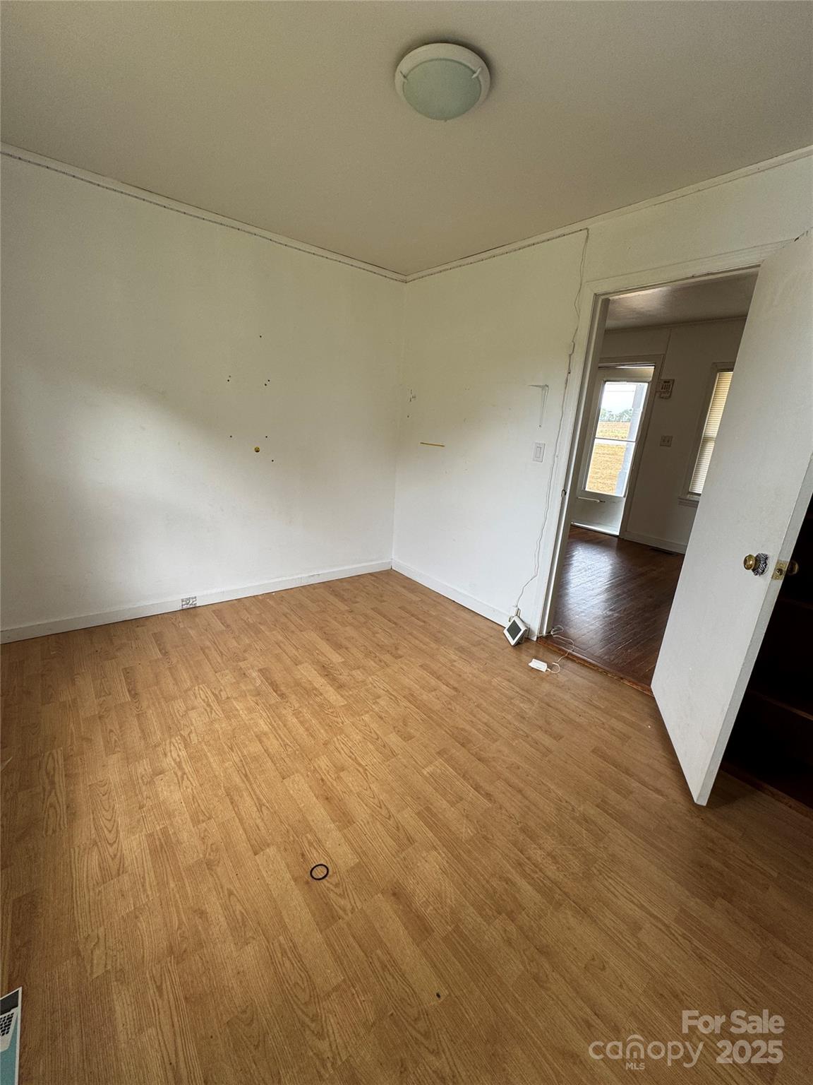 9697 Highway 52 Ansonville, NC 28170 - Photo 8 of 13 a view of empty room with wooden floor and fan