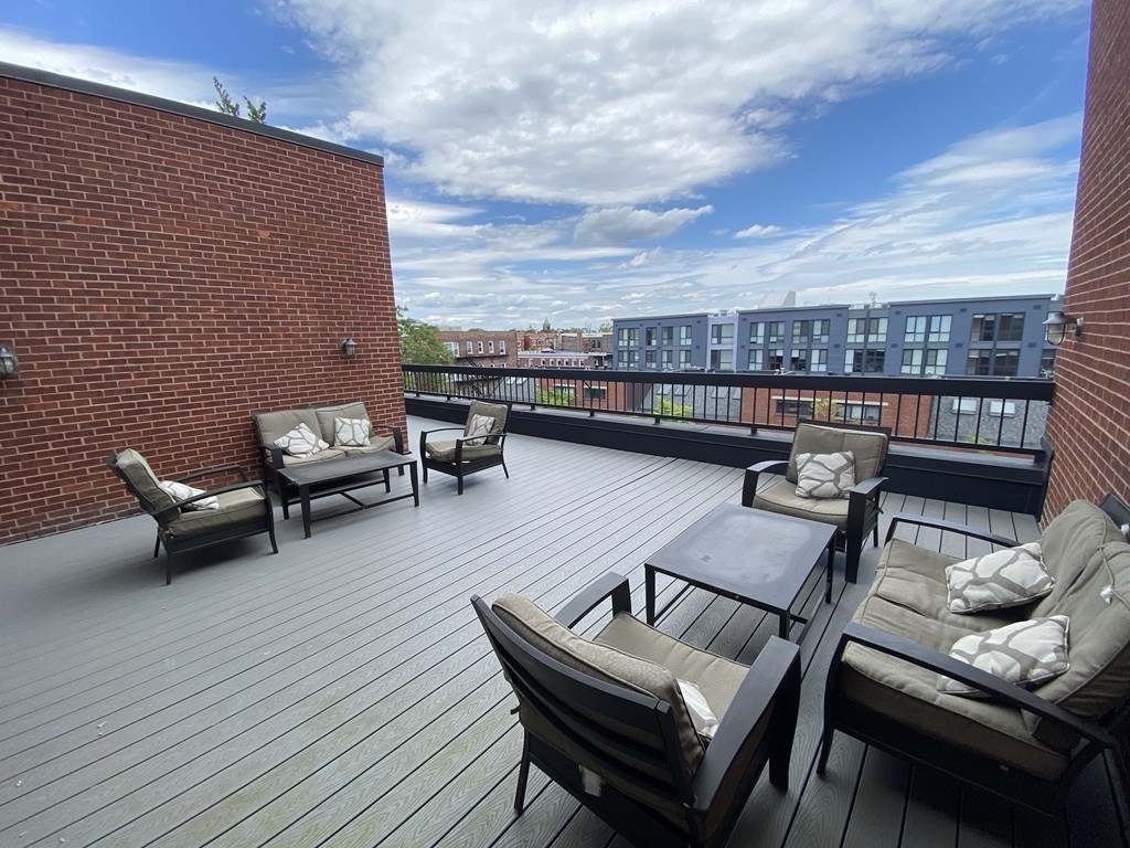 85 Brainerd Road, Unit 510 Boston, MA 02134 - Photo 17 of 25 a view of a terrace with seating area
