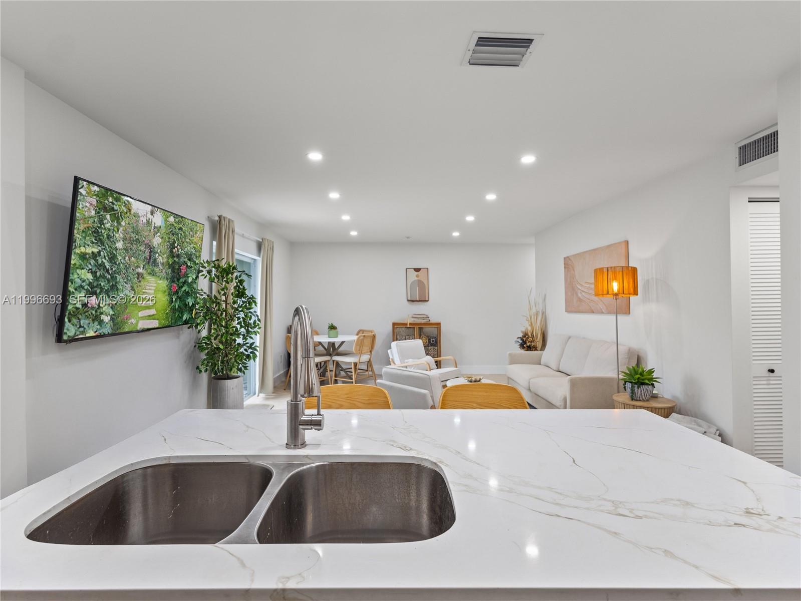 10017 Southwest 23rd Terrace Miami, FL 33165 - Photo 14 of 25 a view of a kitchen with kitchen island and a sink