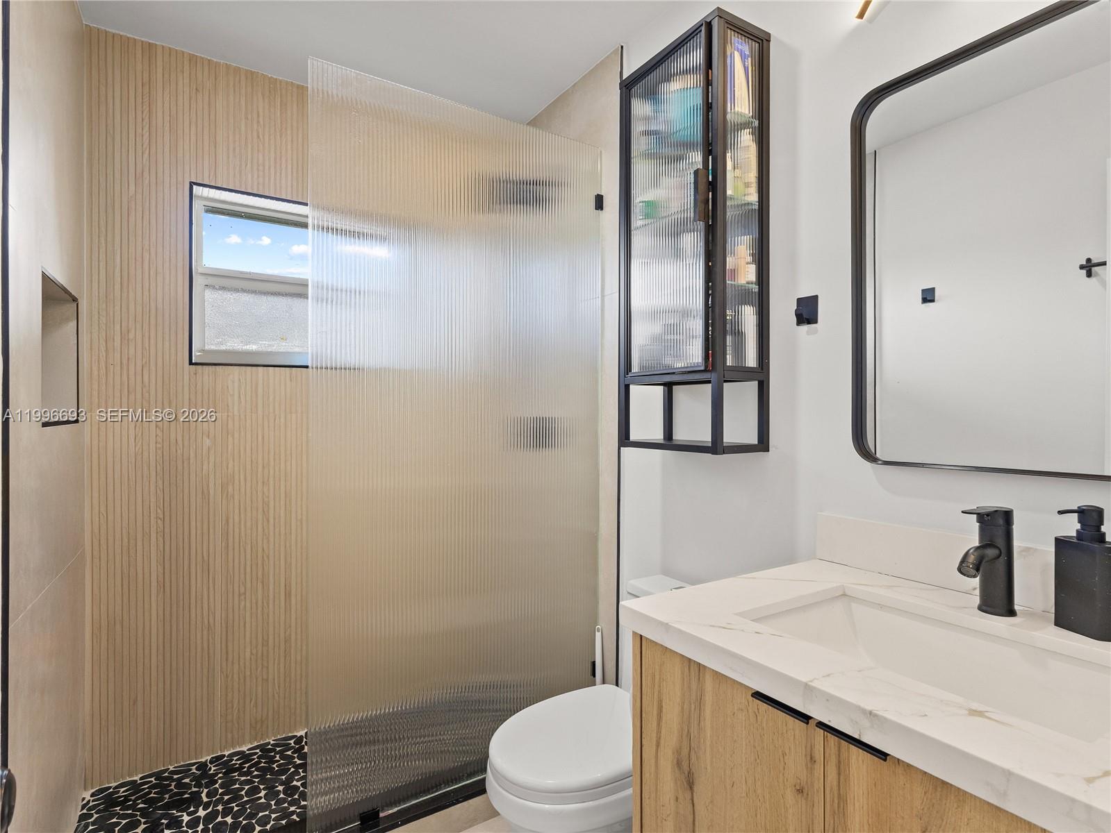 10017 Southwest 23rd Terrace Miami, FL 33165 - Photo 15 of 25 a bathroom with a granite countertop sink toilet and shower