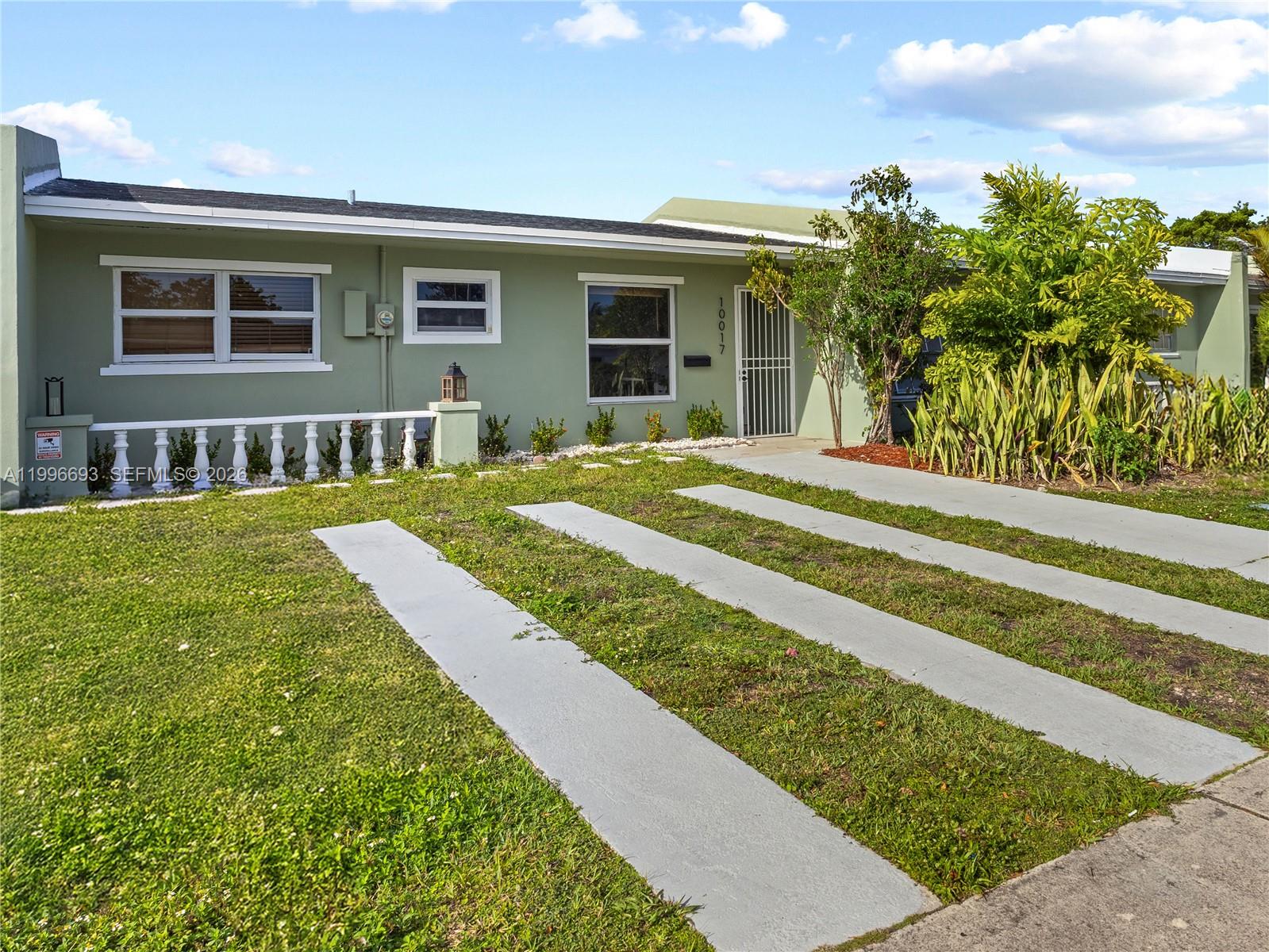 10017 Southwest 23rd Terrace Miami, FL 33165 - Photo 2 of 25 a view of a house with a yard