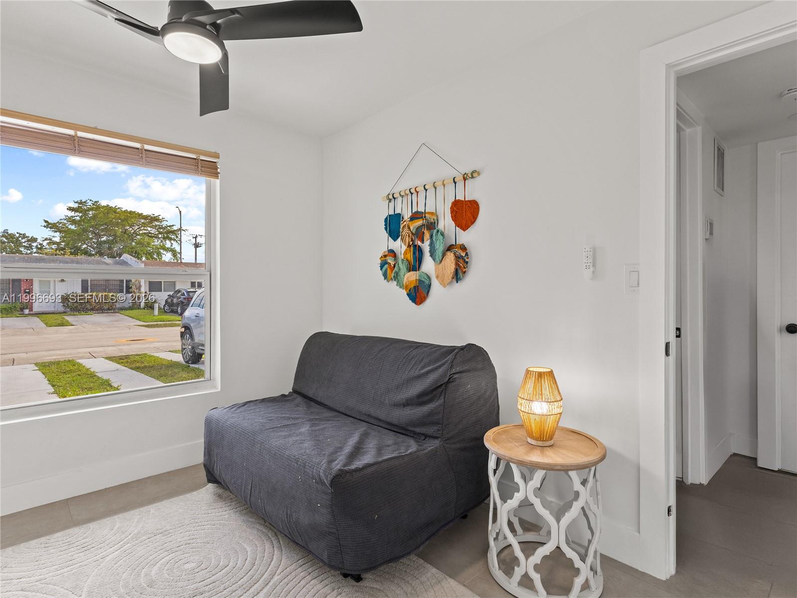 10017 Southwest 23rd Terrace Miami, FL 33165 - Photo 21 of 25 a living room with furniture and a large window