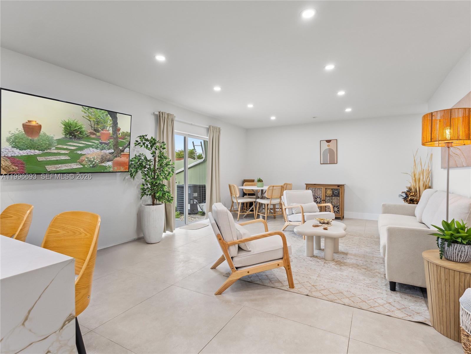 10017 Southwest 23rd Terrace Miami, FL 33165 - Photo 6 of 25 a living room with furniture and a potted plant