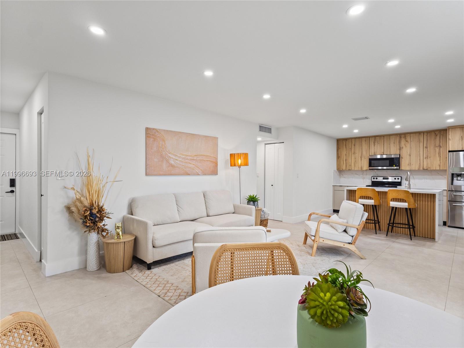 10017 Southwest 23rd Terrace Miami, FL 33165 - Photo 7 of 25 a living room with furniture kitchen view and a potted plant