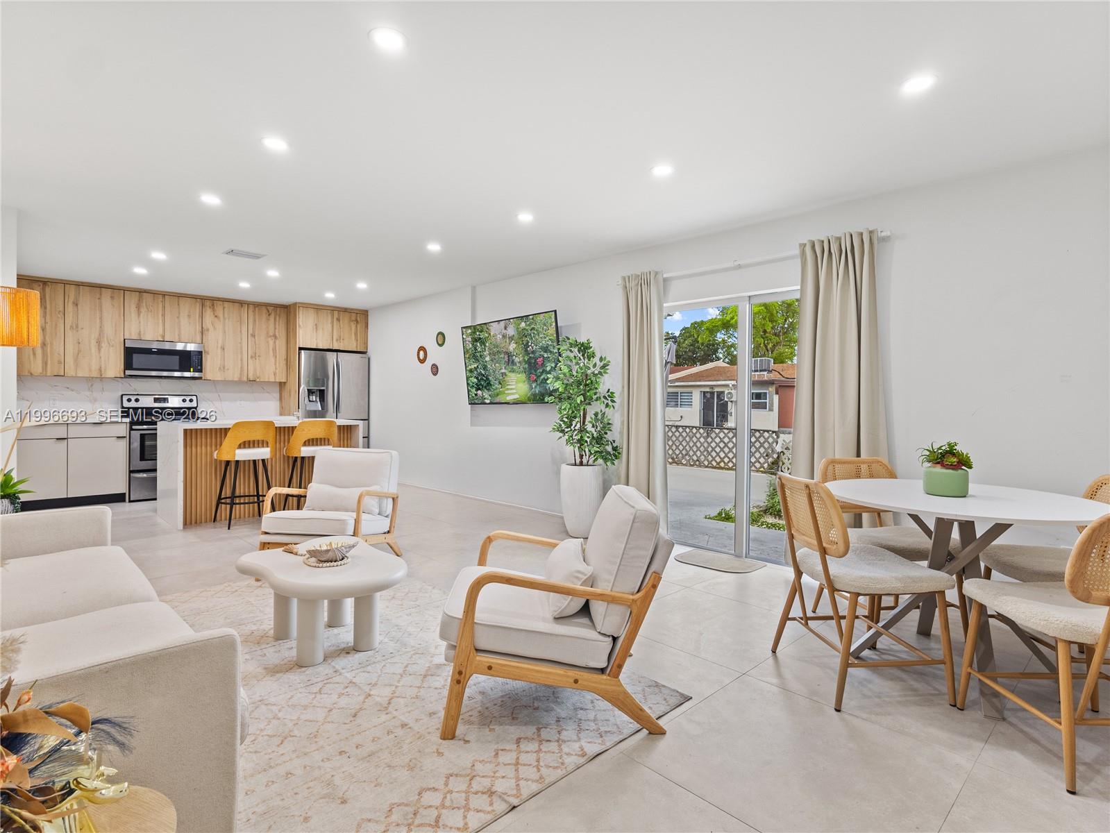 10017 Southwest 23rd Terrace Miami, FL 33165 - Photo 8 of 25 a living room with furniture and a table with chairs