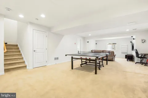 a view of a big room with table and chairs