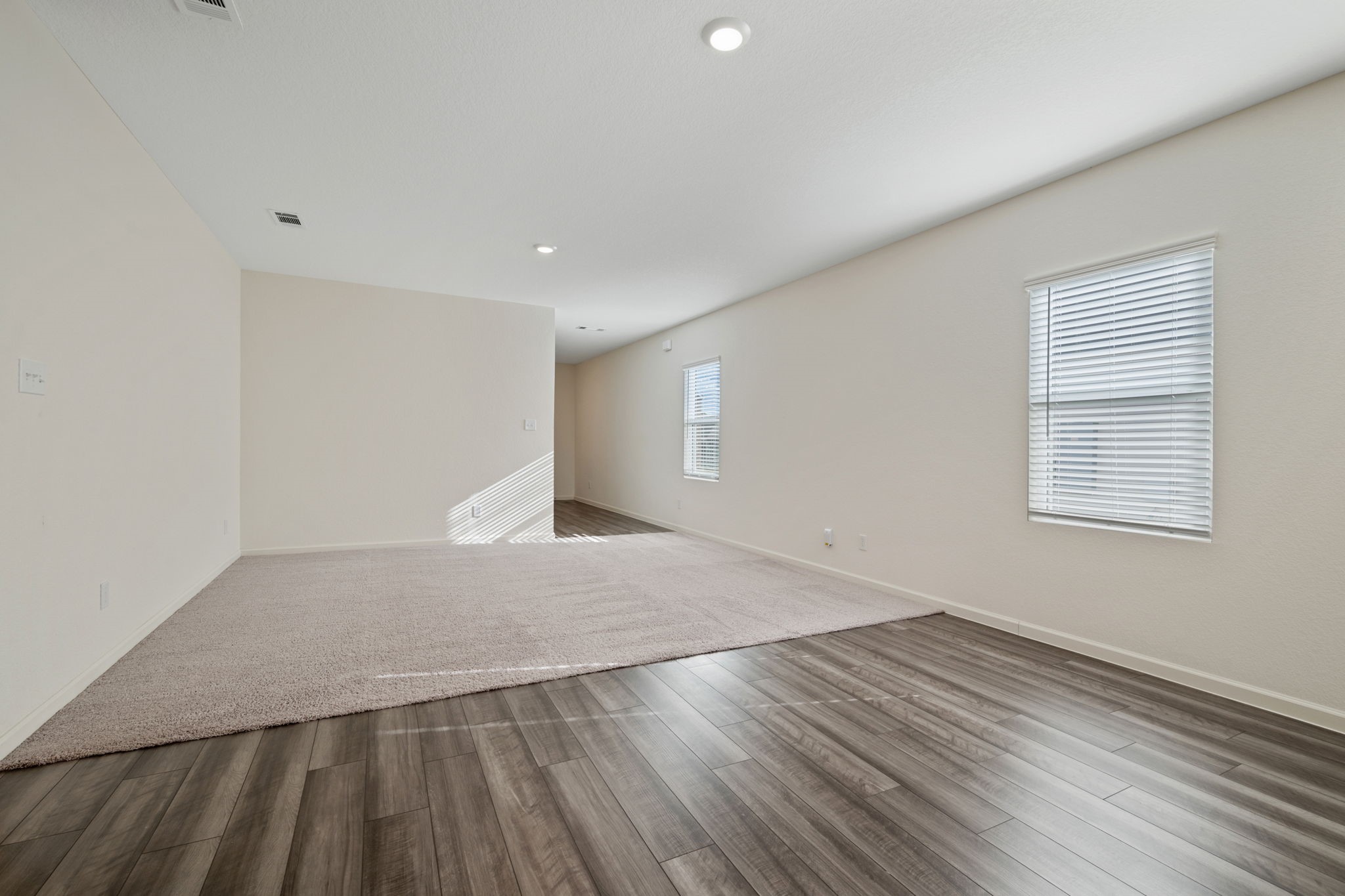 614 Edge Lake Court Montgomery, TX 77316 - Photo 11 of 27 an empty room with wooden floor and windows
