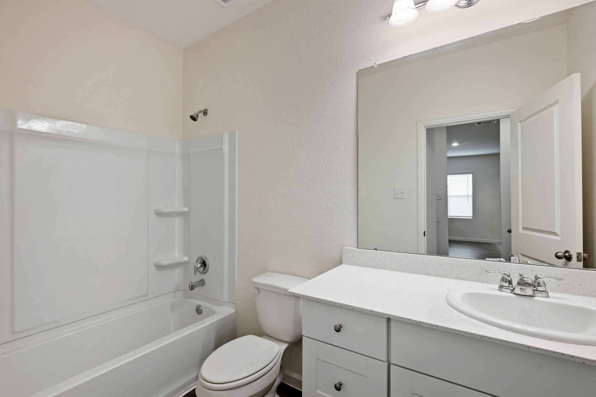 614 Edge Lake Court Montgomery, TX 77316 - Photo 18 of 27 a bathroom with a bathtub shower sink mirror vanity and toilet
