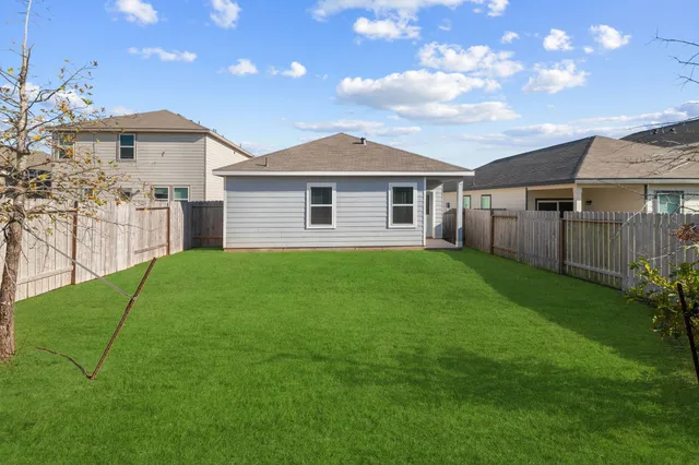 a view of a house with a yard and a garden