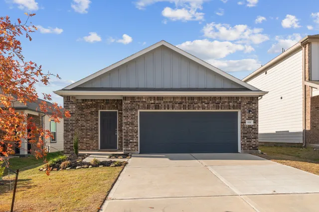 a front view of a house with garage