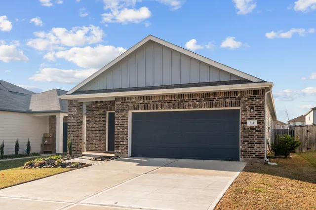 a front view of a house with garage