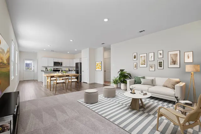 a living room with furniture and kitchen view