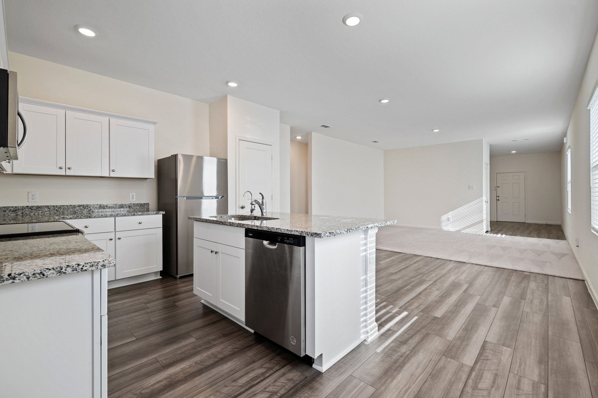 614 Edge Lake Court Montgomery, TX 77316 - Photo 6 of 27 a kitchen with stainless steel appliances granite countertop a stove a sink and a refrigerator