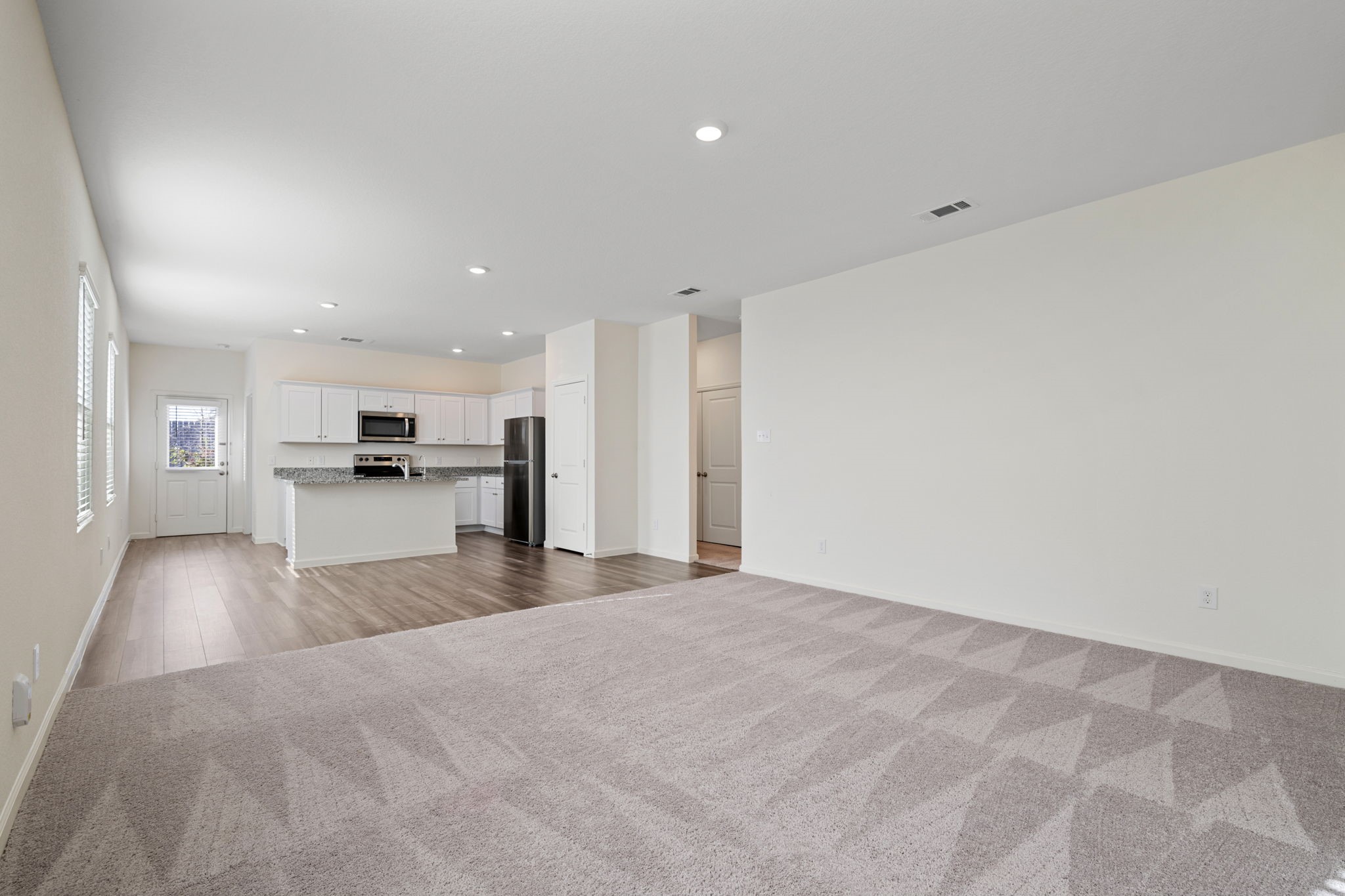 614 Edge Lake Court Montgomery, TX 77316 - Photo 9 of 27 a view of kitchen with refrigerator stove and wooden floor