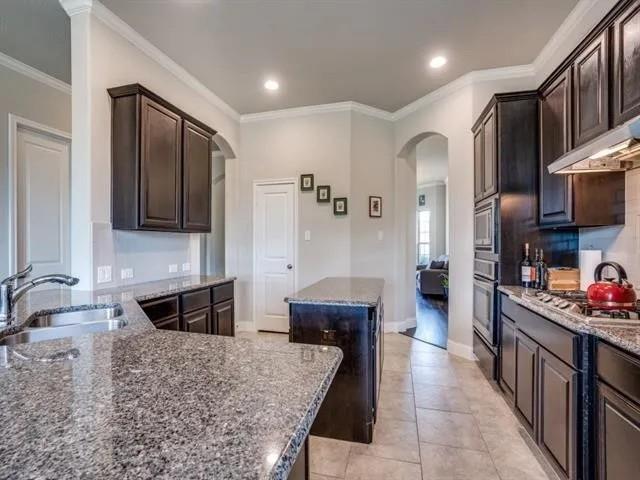 321 Valentino Way Grand Prairie, TX 75052 - Photo 12 of 24 a kitchen with stainless steel appliances kitchen island granite countertop a refrigerator and a stove top oven