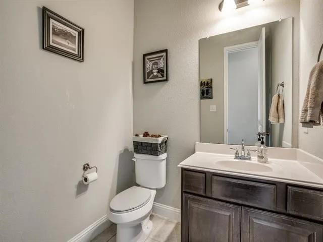 321 Valentino Way Grand Prairie, TX 75052 - Photo 15 of 24 a bathroom with a sink toilet and a mirror