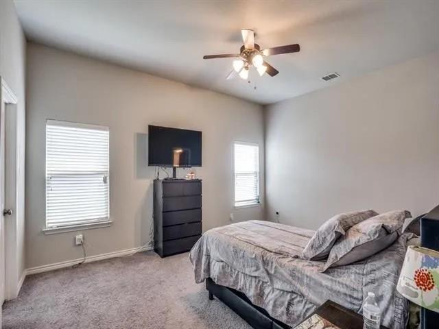 321 Valentino Way Grand Prairie, TX 75052 - Photo 16 of 24 a bedroom with a bed and a chandelier