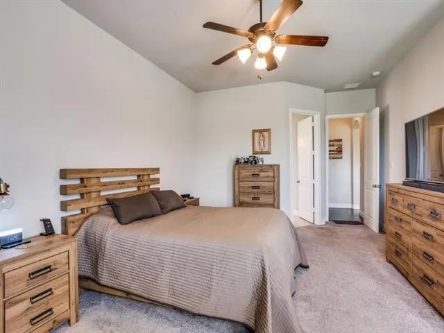 321 Valentino Way Grand Prairie, TX 75052 - Photo 20 of 24 a bedroom with bed and a chandelier