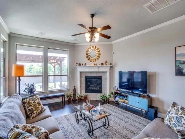 321 Valentino Way Grand Prairie, TX 75052 - Photo 4 of 24 a living room with furniture a window and a fireplace