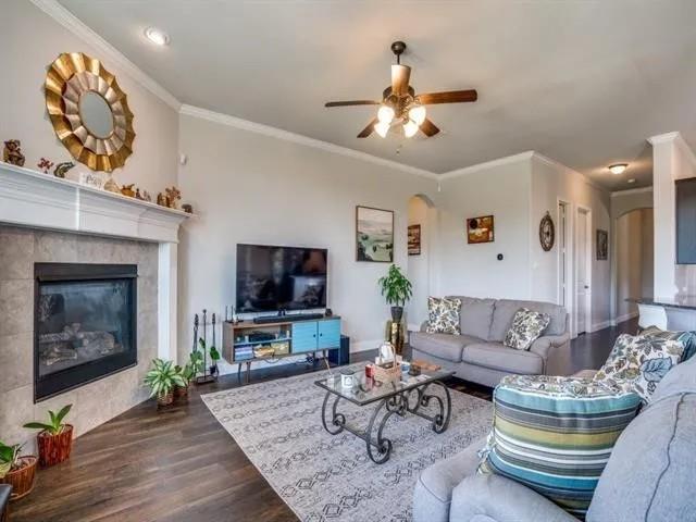 321 Valentino Way Grand Prairie, TX 75052 - Photo 7 of 24 a living room with furniture a fireplace and a flat screen tv