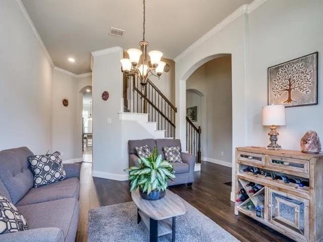 321 Valentino Way Grand Prairie, TX 75052 - Photo 8 of 24 a living room with furniture chandelier and a fireplace