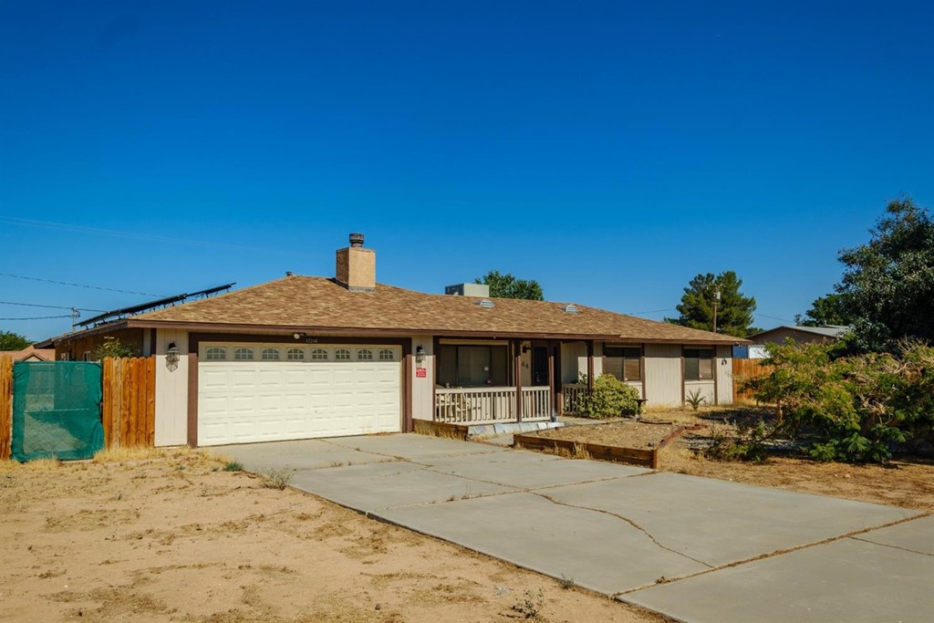 12244 Snapping Turtle Road Apple Valley, CA 92308 - Photo 1 of 1 a front view of a house with a garden
