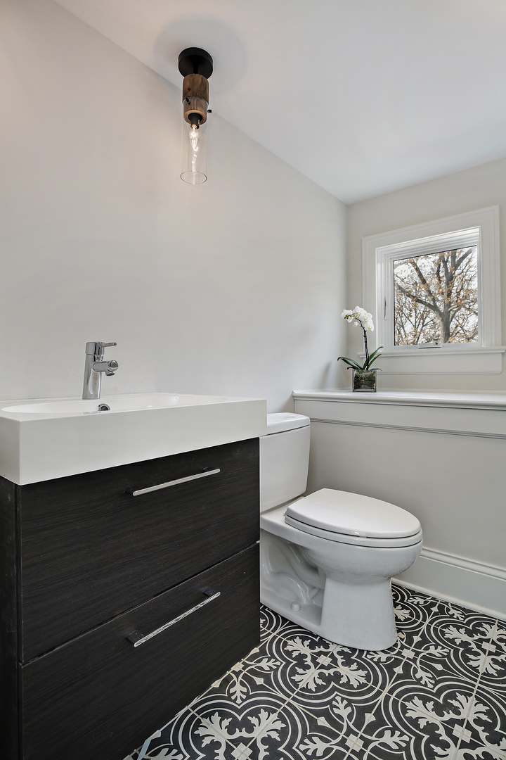1401 Maple Avenue Wilmette, IL 60091 - Photo 37 of 46 a bathroom with a sink a toilet and a mirror