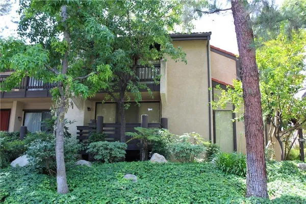 front view of a house with a tree in front