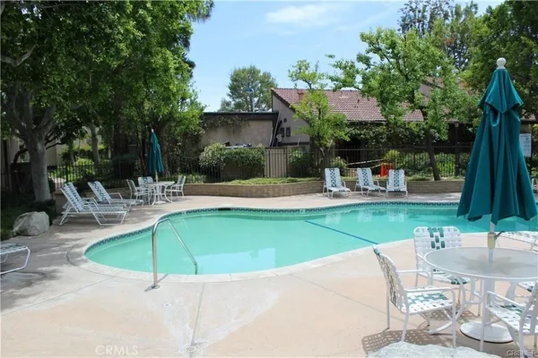 a swimming pool with outdoor seating and yard