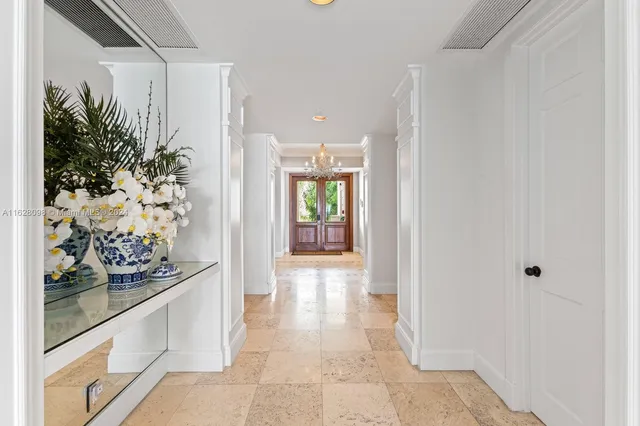 a kitchen with a refrigerator and white cabinets
