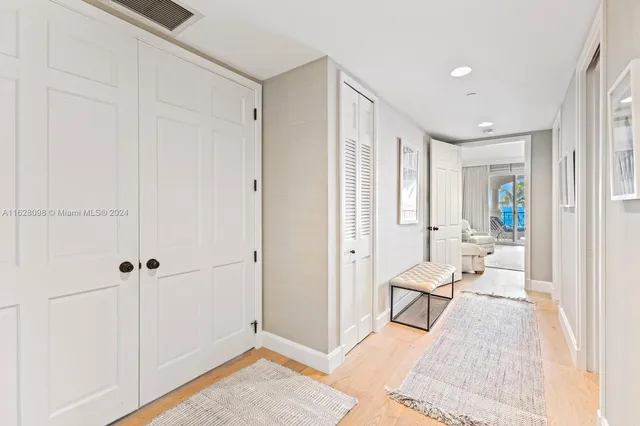 a bedroom with a bed and large windows