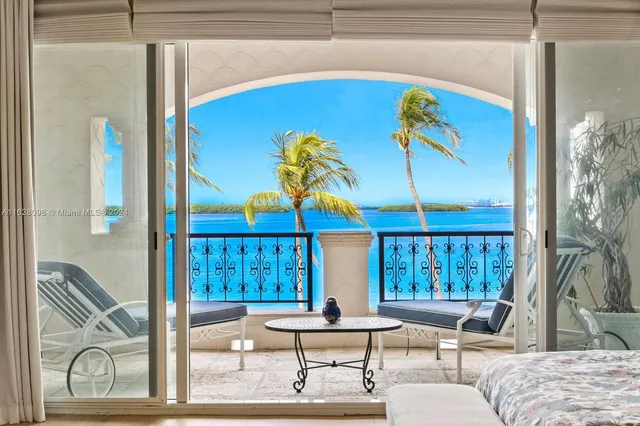 a bedroom with furniture and a large window