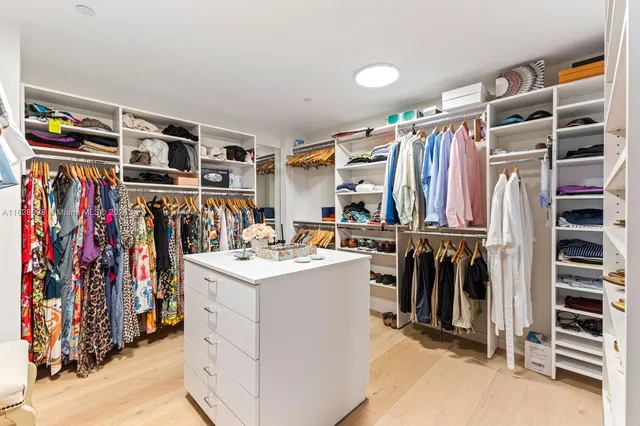 a spacious bathroom with a double vanity sink mirror and bathtub