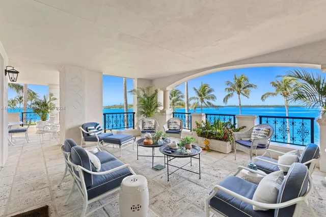 a living room with furniture a rug and a large window