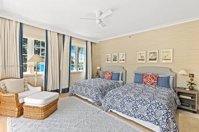 a bedroom with furniture and a large window