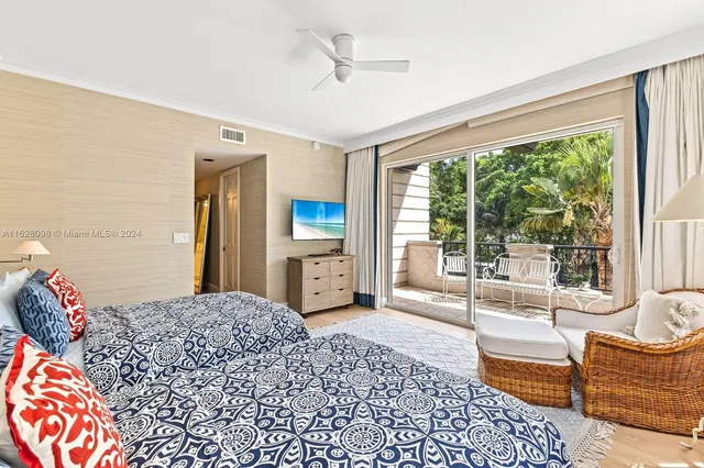 a bedroom with a large bed and a large window